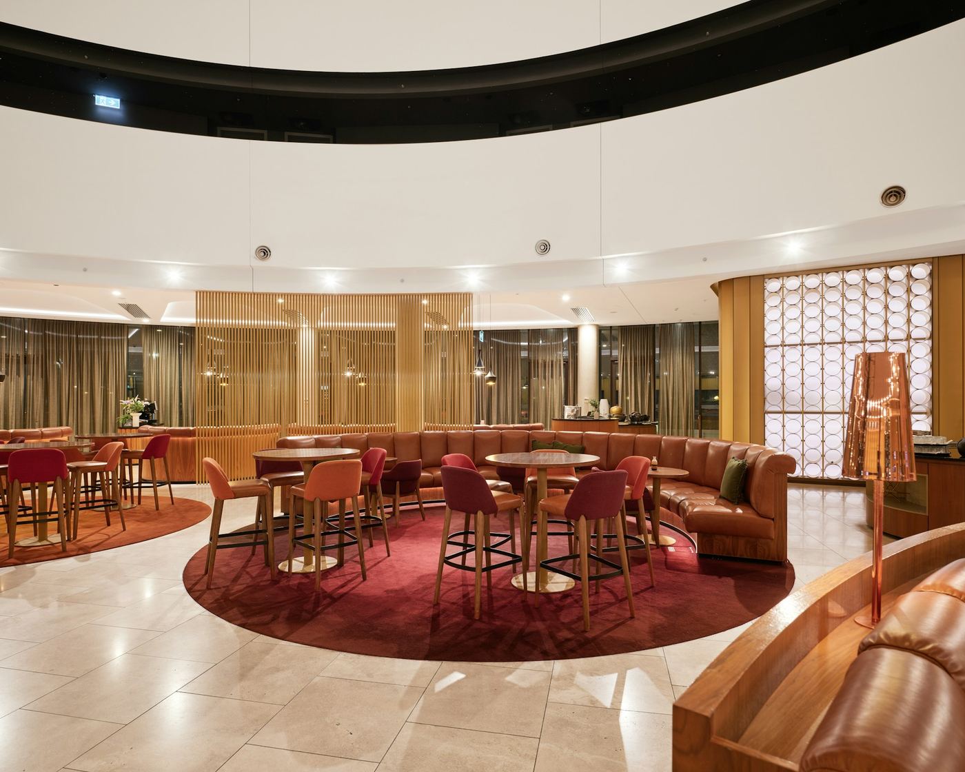 Hotel lounge with warm pendant and ceiling lighting