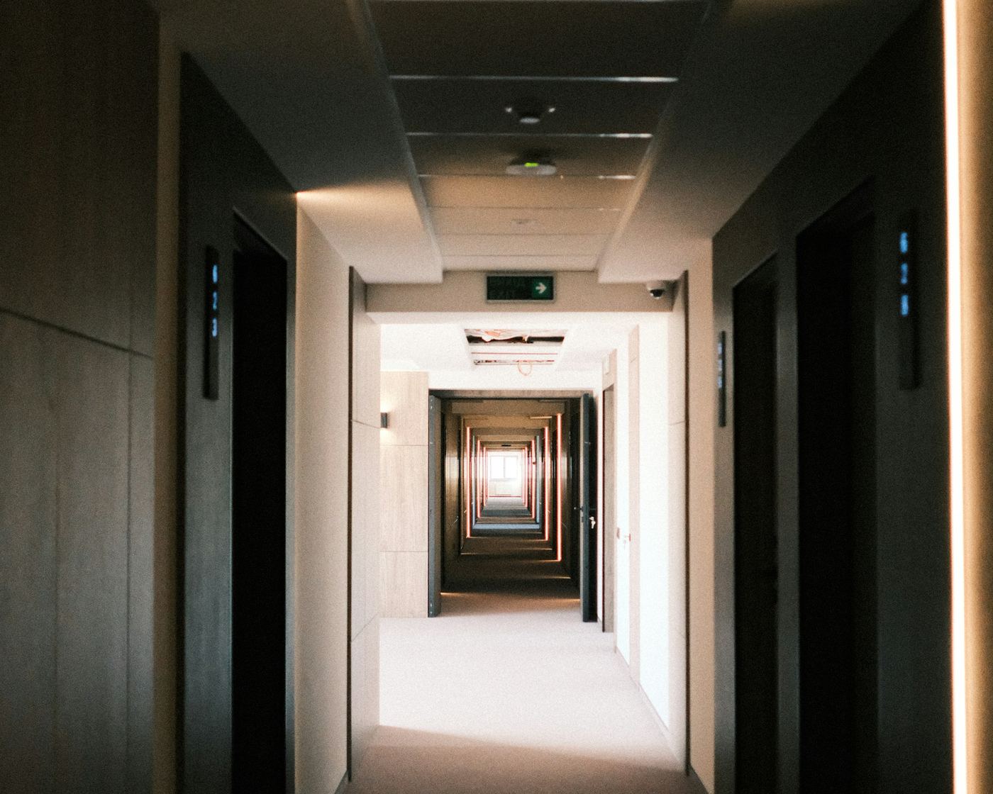 Hotel corridor with a ceiling-mounted motion sensor